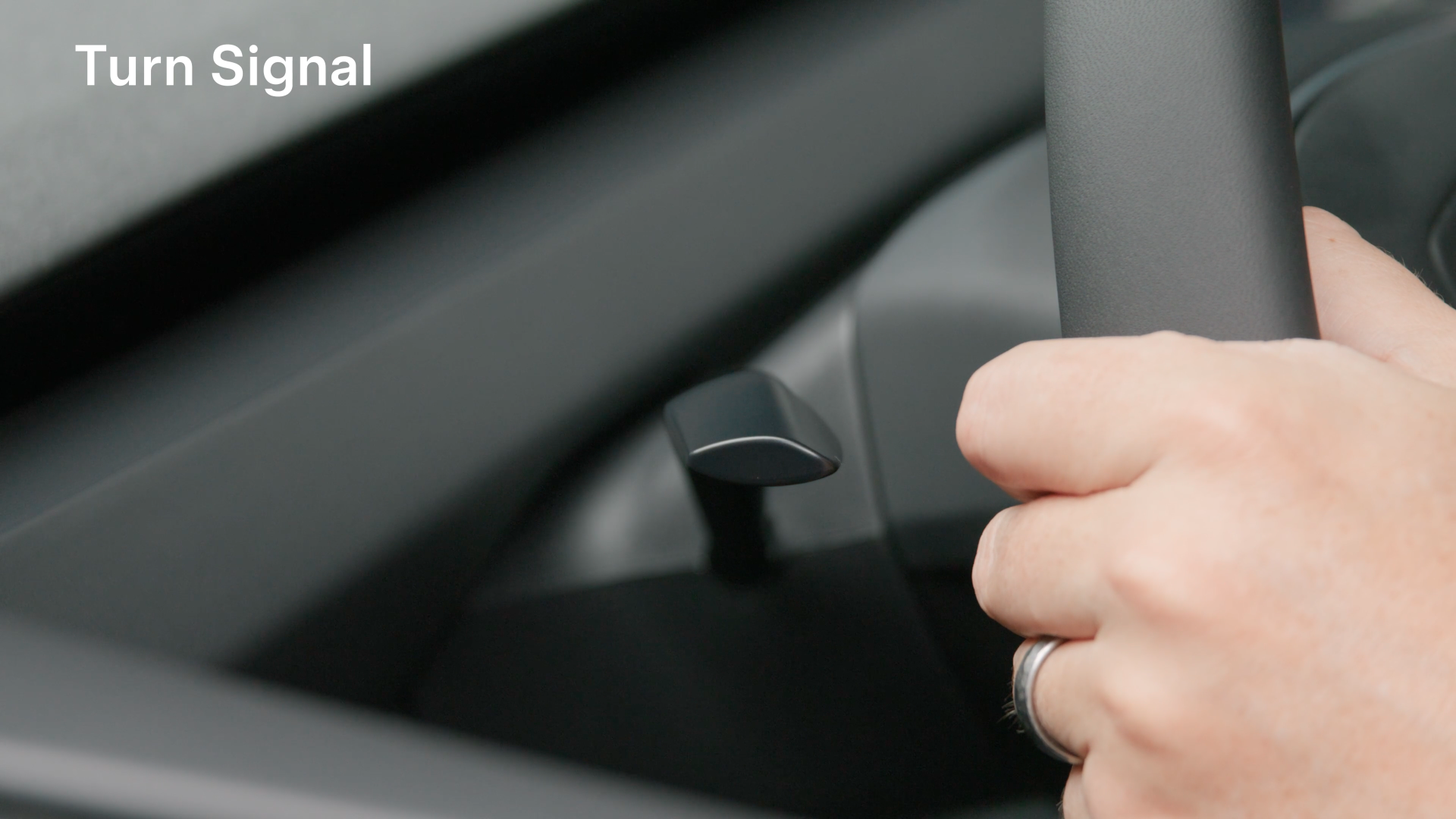 Using the turn signal on a Tesla steering wheel